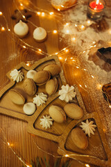 sweets and cookies on christmas table on wood stand