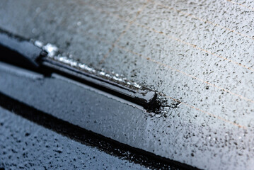 Rear car windscreen wipers frozen on winter morning. Close up view. - obrazy, fototapety, plakaty