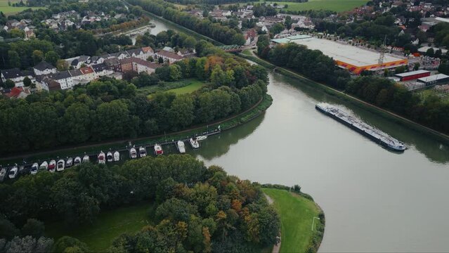 Drone aerial view of water canal with cargo ships, marina with boats at small town Datteln, Germany