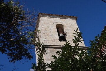 Church of the Assumption, Cadalso de los Vidrios, Madrid, Spain, November 18, 2023: Bell tower of...