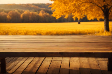 Naklejka na ściany i meble empty wooden table with beautiful autumn golden yellow meadow background
