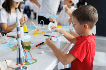 Child models a mock-up of an airplane. A preschooler is engaged in creativity. Children's creativity