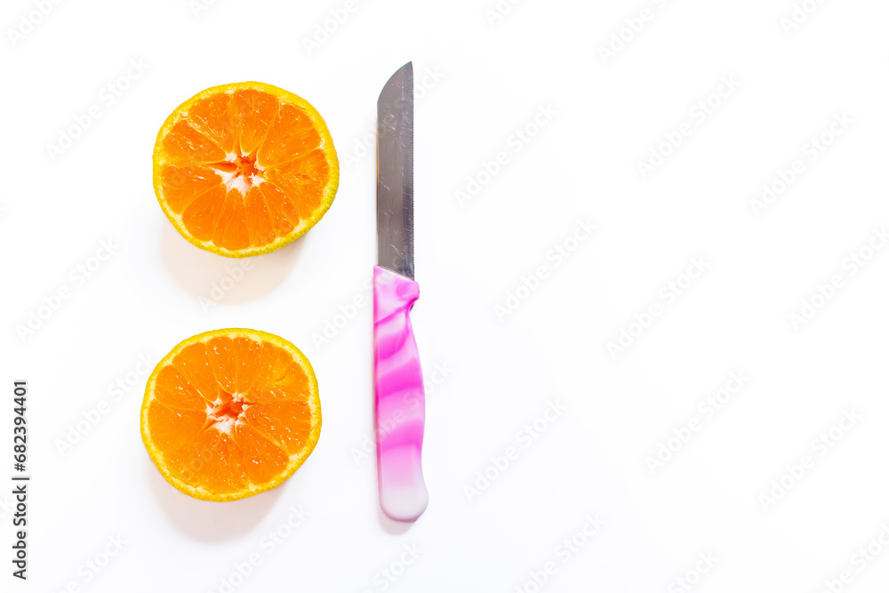 Poster sliced tangerine isolated on a white background with a knife. top view, copy space.