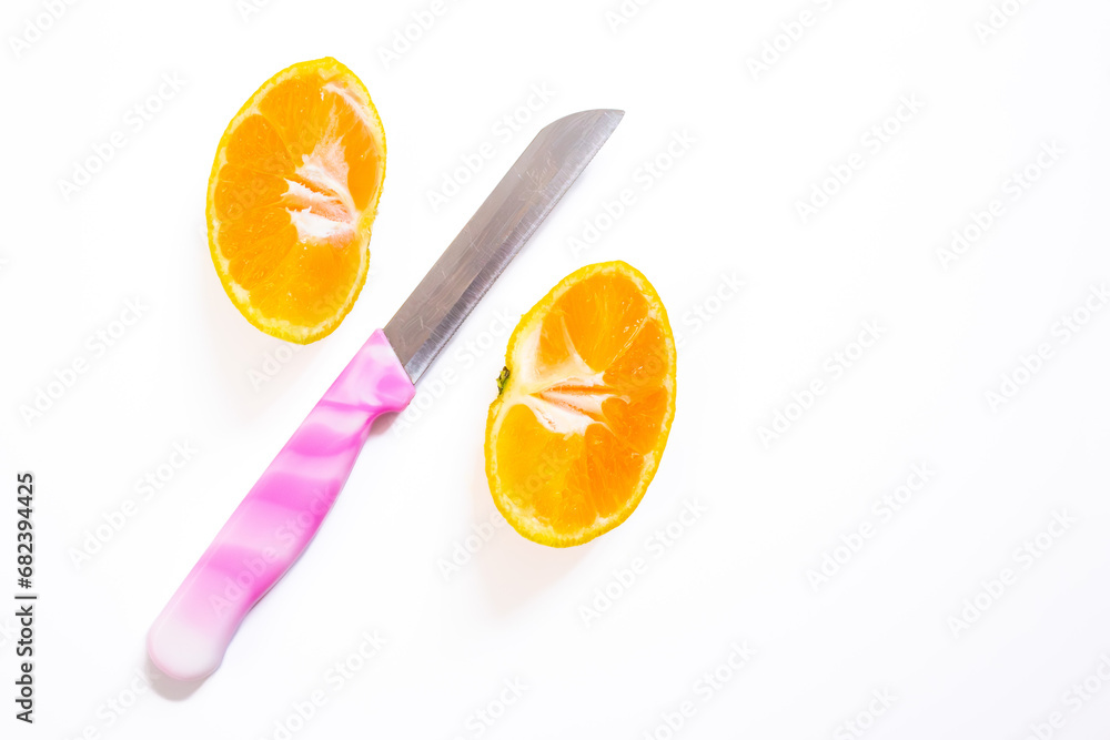 Poster sliced tangerine isolated on a white background with a knife. top view, copy space.