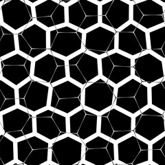 Abstract pattern with a bold black and white honeycomb motif on a black background, featuring a mesh-like design