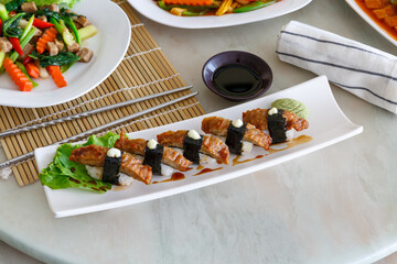 Japanese food But vegetarian food, sushi unagi gunkan roll plate or platter set. Chopsticks, ginger, wasabi, and soy sauce. Sushi with eel. vegetarian food