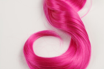 Natural looking shiny hair pink bright color, cosplay wig on a white background