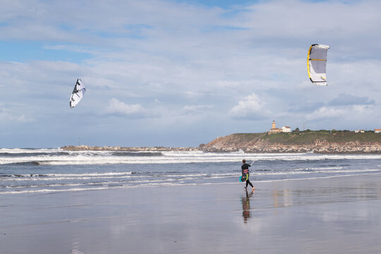 Young man practices kitesurfing on Salinas Beach, Asturias