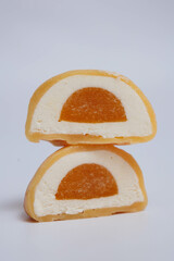 Japanese rice desert mochi closeup. Colouful mochi cakes sliced. Tasty fruit and chocolate mochi on grey background. Traditional cold ice asian candy. Dry fruits and nuts.