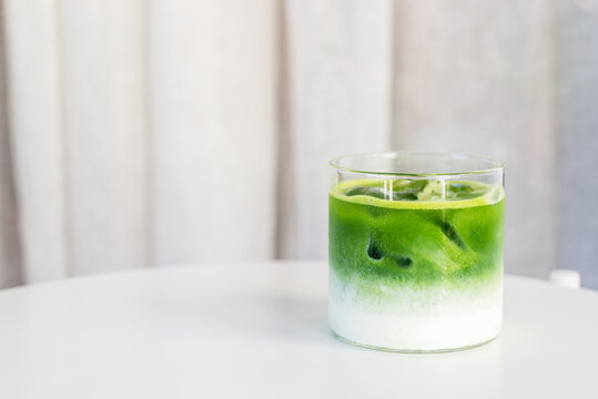 ice matcha latte on white table.