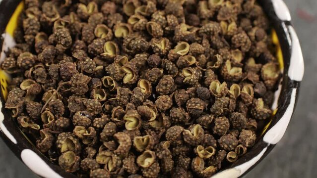 Dried black pepper rotating top view. A bunch of natural black pepper peas hot spice.Seasonings and condiments concept