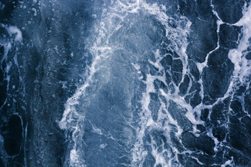 Abstract blue background white veins, ocean wave, bubble and foam at high tide, pattern