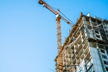 Construction of a building. Construction site with crane. Business, development, industry.