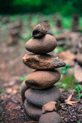 Fototapeta na wymiar Stack of pebble stones in the forest. Zen concept.