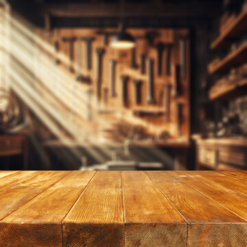 Worn old wooden table and workshop interior. Retro vintage photo of background and mockup. Sun light and dark shadows.