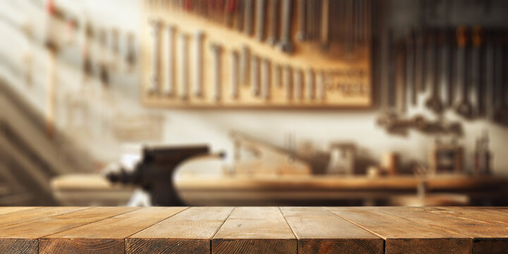 Worn old wooden table and workshop interior. Retro vintage photo of background and mockup. Sun light and dark shadows.
