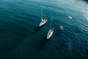 Aerial view of luxury yachts, sailing yachts, clear blue water. Travel. Cruise vacation. Yachting.