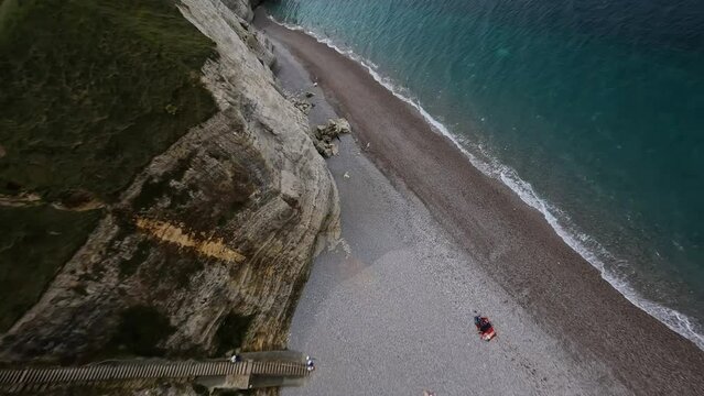 Beach filled with pebles, Cliffs of Normandy.