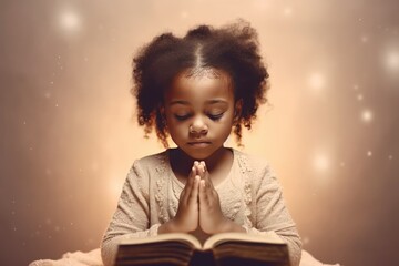 Little black girl on knees holding hands and praying in the morning, pastel neutral background. Christianity, faith, spirituality, religion, salvation, peace, faith concept. Kid praying to God - obrazy, fototapety, plakaty