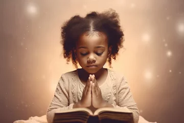 Fotobehang Little black girl on knees holding hands and praying in the morning, pastel neutral background. Christianity, faith, spirituality, religion, salvation, peace, faith concept. Kid praying to God © jchizhe