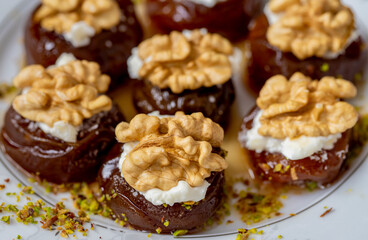 Traditional stuffed dried fig dessert with walnuts and cream, cooked with syrup (Turkish name: fig dessert with cream).​