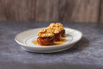 Traditional stuffed dried fig dessert with walnuts and cream, cooked with syrup (Turkish name; Walnut fig dessert)