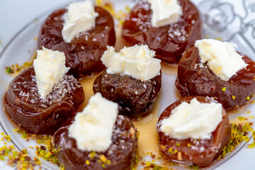 Traditional stuffed dried fig dessert with walnuts and cream, cooked with syrup (Turkish name: fig dessert with cream).​
