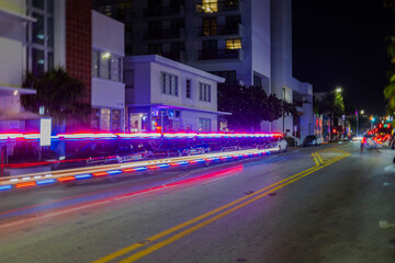 Captivating night scene of Miami Beach cityscape illuminated by mesmerizing defocused light trails...