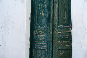 old wooden green door, poor house with rustic paint