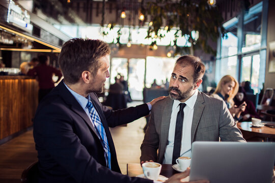 Serious Discussion Between Colleagues in a Cafe