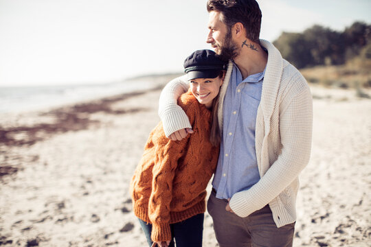 Couple Enjoying a Romantic Walk on the Beach