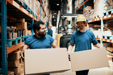 Diverse warehouse workers working and carrying boxes in a warehouse