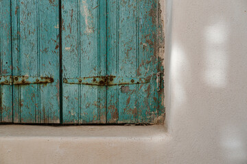 old green blue mint color wooden window shuttles in whitewashed greek aegean house property
