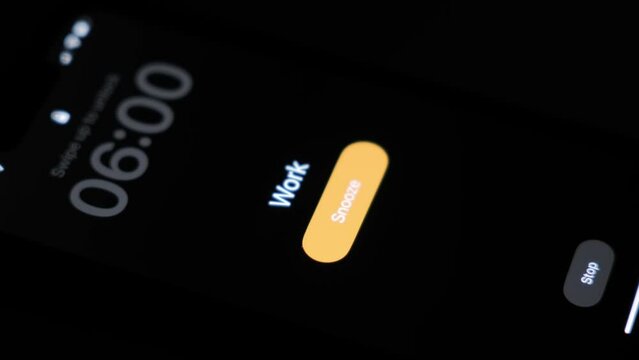 A close-up of an alarm clock ringing on a mobile phone smartphone with a reminder to go to work at 6 o'clock in the morning. High quality 4k footage