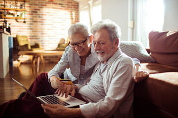 Elderly senior couple online shopping from home