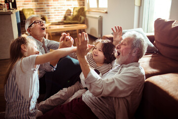 Grandparents having fun with Grandkids in the living room