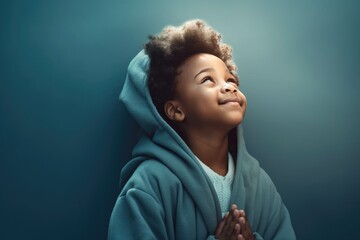 Little black boy on knees holding hands and praying in the morning, pastel neutral background. Christianity, faith, spirituality, religion, salvation, peace, faith concept. Kid praying to God - 682446077