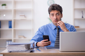 Young male employee working in the office