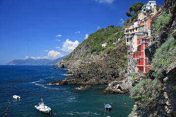 riomaggiore a village of the cinque terre on the ligurian coast with its colorful houses and boats...