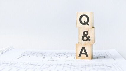 text Q and A on wooden cube blocks stack on wood table on white background with copy space
