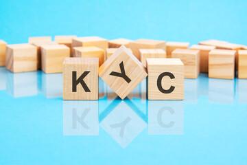 KYC on wooden cubes on blue background