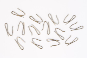 Drapery Hooks Scattered on White Background