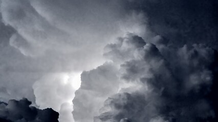 Dark blue and grey clouds with blinking thunders before thunderstorm and heavy rain