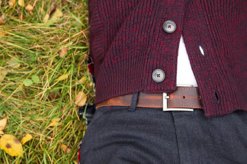 Male fall style cloth. Autumn fashion outfit for men. Closeup. Knitted sweater with buttons,...