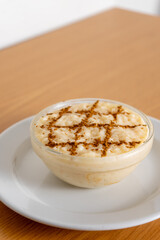 Delicious Portuguese rice pudding, a creamy traditional dessert topped with cinnamon, perfect for a sweet treat. Authentic taste captured!