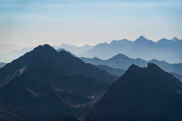 Silhouettes of Italian Alps mountain ridges in summer