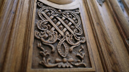 Beautiful elegant adornment ornamentation engraved on wooden ancient door, traditional antique building architecture