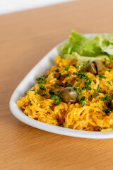 Classic Portuguese dish, Bacalhau à Brás, served in a cozy snack bar – a delicious blend of shredded cod, eggs, and crispy potatoes.