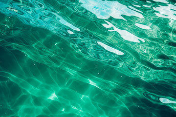 Naklejka premium Crystal clear turquoise water with gentle waves and light reflections, perfect for a refreshing and serene background.