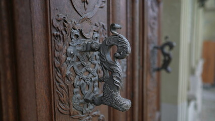 Beautiful door knob in traditional antique wooden doorway with adornment and ornamentation